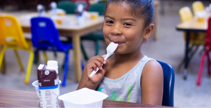 Little girl eats breakfast