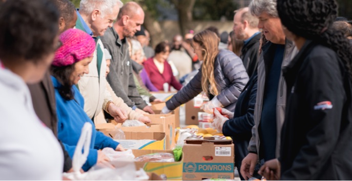 Volunteers hand out food to clients