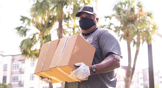 Feeding Tampa Bay staff carries a box of food