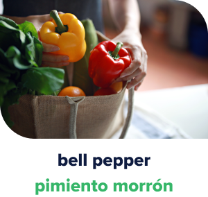 Hands putting away yellow and red bell peppers into a grocery tote bag.