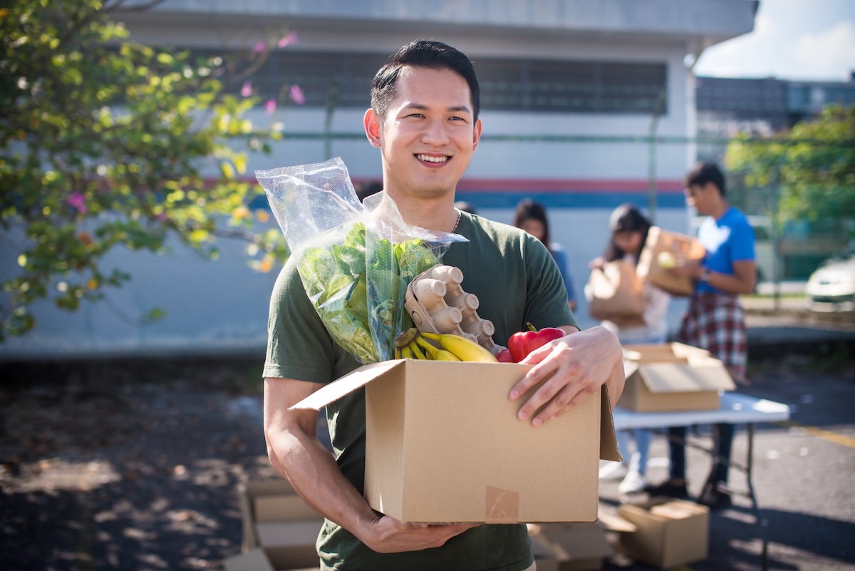 Adult man holding a box of groceries